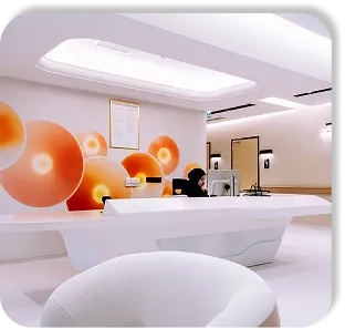The front desk, under a wall of orange spheres