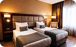 A twin room, two beds under a padded headboard